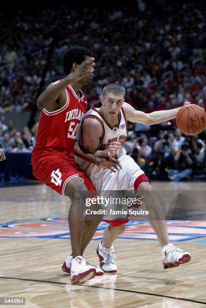 Steve Blake of Maryland attempts to dribble around Jeff Newton of Indiana during the men's NCAA National Championship game at the Georgia Dome in...