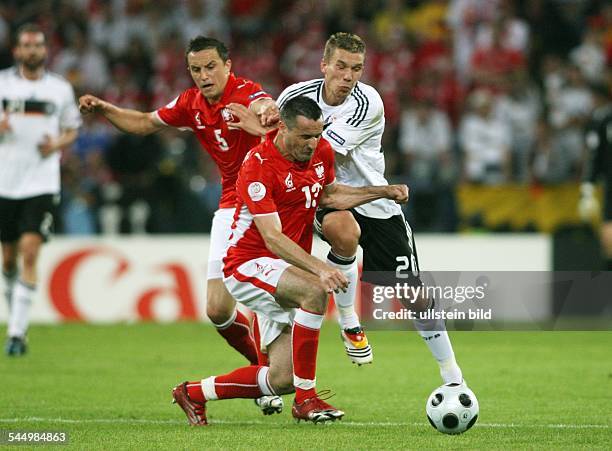 Austria - Klagenfurt: UEFA EURO 2008 - Group B, Germany v Poland 2:0 - Lukas Podolski battling for the ball with Poland's Dariusz Dudka and Marcin...