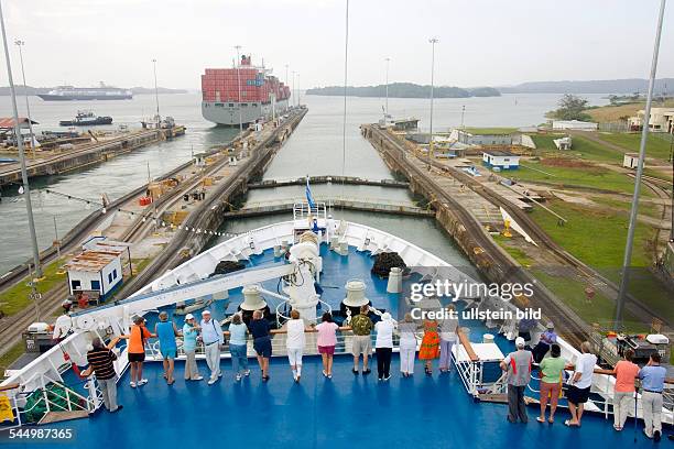 Panama - Panamakanal: Panama Canal: Cruise ship MS ASTOR leaves the third Gatun lock chamber for Gatun Lake. In the background, Panamax Containership...