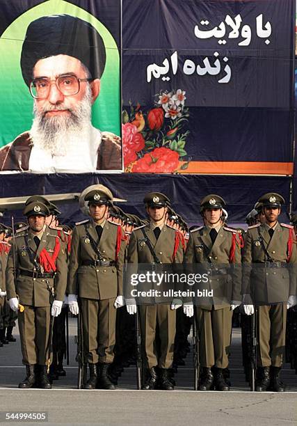 Iran - Teheran Tehran: Officers and soldiers of the iranian army during a parade. In the background a picture of Ayatollah Ali Khamenei