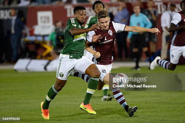 Colorado Rapids forward Kevin Doyle fights for the ball with Portland Timbers defender Jermaine Taylor during the second half on July 4, 2016 at...
