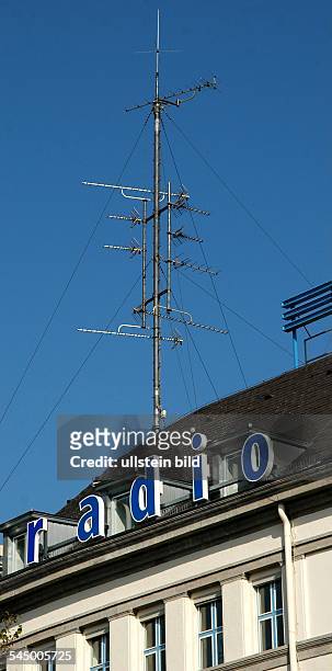 Germany - Berlin - : aerial mast and emblem of the radio station Deutschlandradio on the roof of the RIAS broadcasting centre