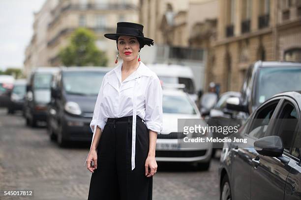 Designer Ulyana Sergeenko wheres a black and white outfit with a hat at the Dior show at 30 Avenue Montaigne on July 4, 2016 in Paris, France.