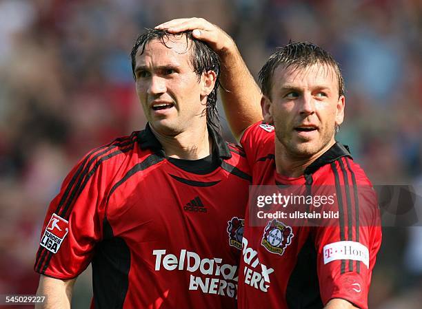 Bernd Schneider - Midfielder, Bayer 04 Leverkusen, Germany - patting head of teammate Theofanis Gekas