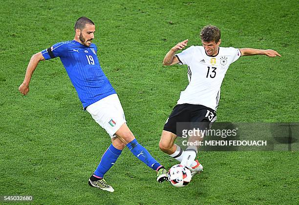 Italy's defender Leonardo Bonucci vies with Germany's midfielder Thomas Mueller during the Euro 2016 quarter-final football match between Germany and...