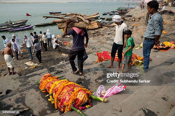 Corpse is lying to be cremated at Manikarnika ghat in Varanasi. It is a traditional holy place on the banks of river Ganges to cremate dead bodies of...