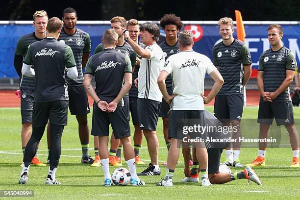 Joachim Loew, head coach of Germany talks to his players prior to a Germany training session at Ermitage Evian on July 05, 2016 in Evian-les-Bains,...