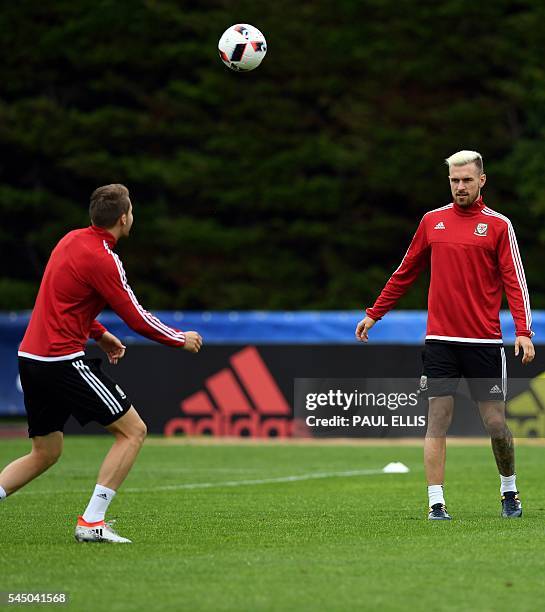 Wales' defender Chris Gunter and Wales' midfielder Aaron Ramsey take part in a training session in Dinard, northwestern France, on July 5 a day ahead...