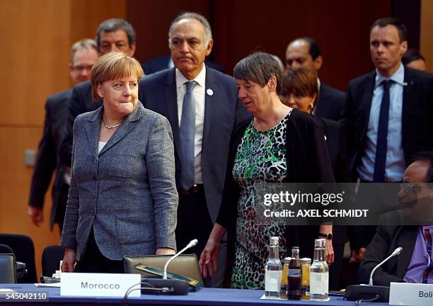 German Chancellor Angela Merkel , Morocco's Foreign Minister Salaheddine Mezouar and German Environment Minister Barbara Hendricks arrive for the...