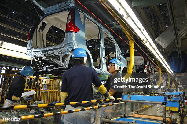 Workers assemble vehicles at the production line at the Mitsubishi Motors Mizushima Plant on July 4, 2016 in Kurashiki, Okayama, Japan. The fuel...