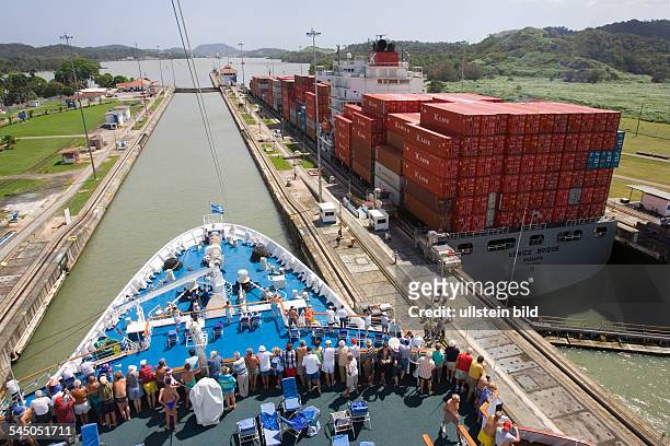 Panama - : Cruise ship MS ASTOR passing the Panama Canal heading for the Pacific Ocean. Inside the Pedro Miguel lock. On the right: Panamax container...
