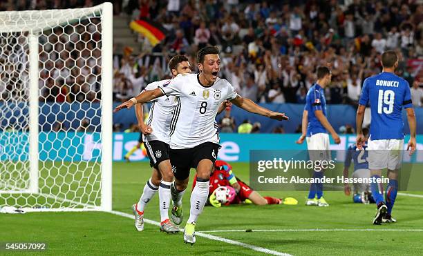 Mesut Oezil of Germany celebrates scoring the opening goal during the UEFA EURO 2016 quarter final match between Germany and Italy at Stade Matmut...