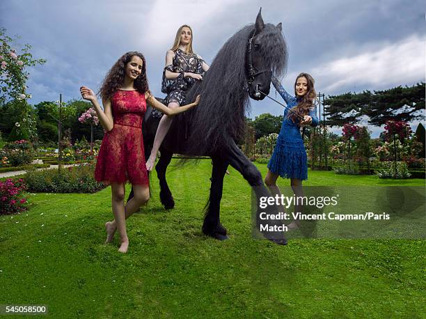 Iman Perez, Mathilde Pinault and Flore Giraud are photographed for Paris Match with a horse called Le Frison in the Bagatelle gardens on June 22,...