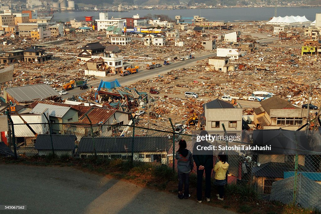 Parent and children who look at stricken area that was...