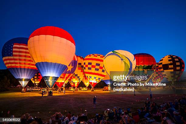 balloon glow - hot air balloon festival stock pictures, royalty-free photos & images