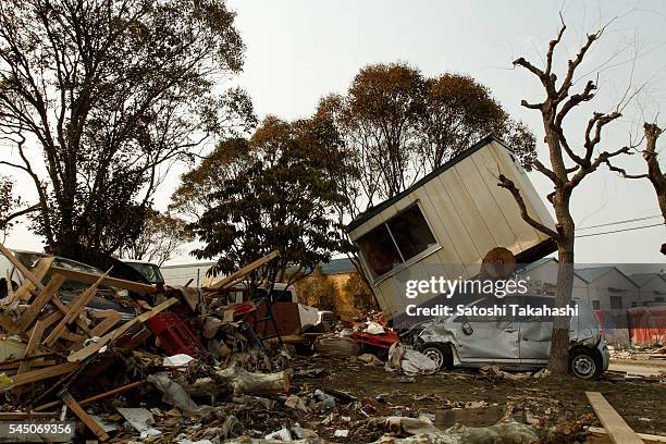 Houses and a car which were devastated by the earthquake and tsunami that hit northeastern Japan on March 11, 2011.