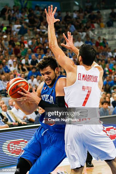 The tunisian guard Mourad El Mabrouk defends against a drive to the basket by The italian point guard Alessandro Gentile in the match between Italy...