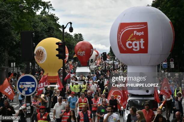 People hold flags of French trade union CGT during a demonstration against proposed government labour and employment law reforms on July 5, 2016...