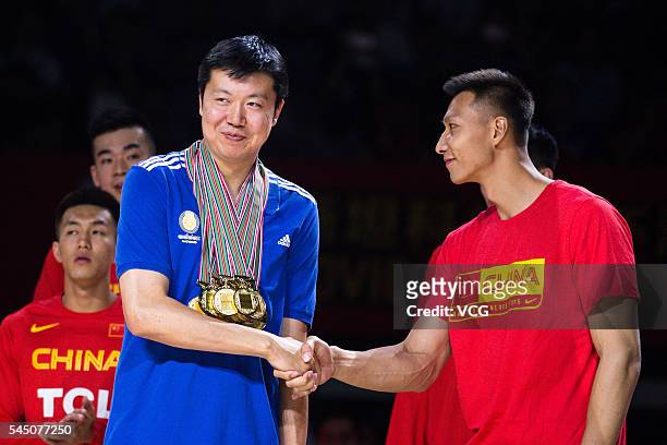 Wang Zhizhi and Yi Jianlian attend Wang Zhizhi's retirement ceremony during a match of the Stankovic Continental Cup 2016 on July 5, 2016 in Beijing,...