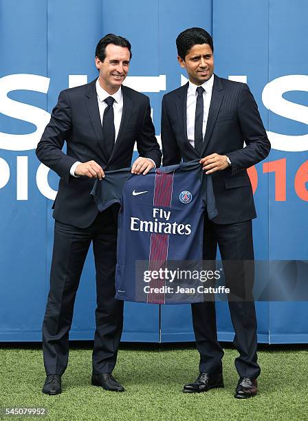 President of PSG Nasser Al-Khelaifi presents a jersey of Paris Saint-Germain to new coach of PSG Unai Emery of Spain at Parc des Princes stadium on...
