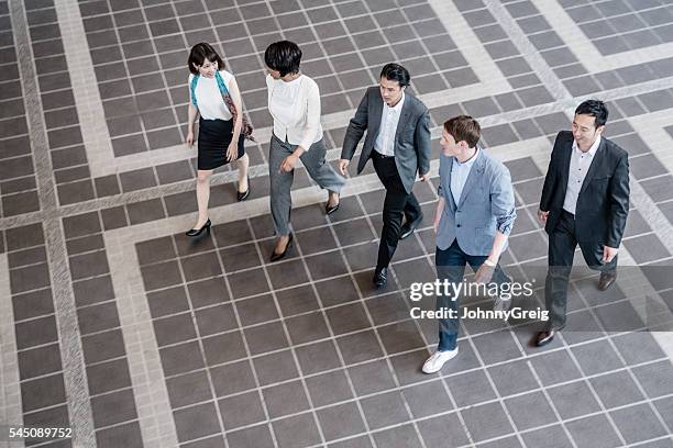 group of business people walking together, high angle view - black man high 5 stockfoto's en -beelden