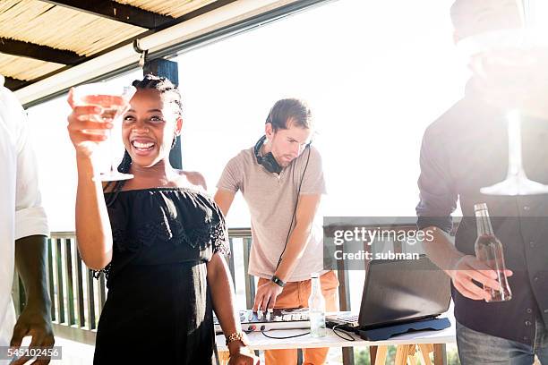 cheerful group of friends enjoying an outdoor party - dj summer stockfoto's en -beelden