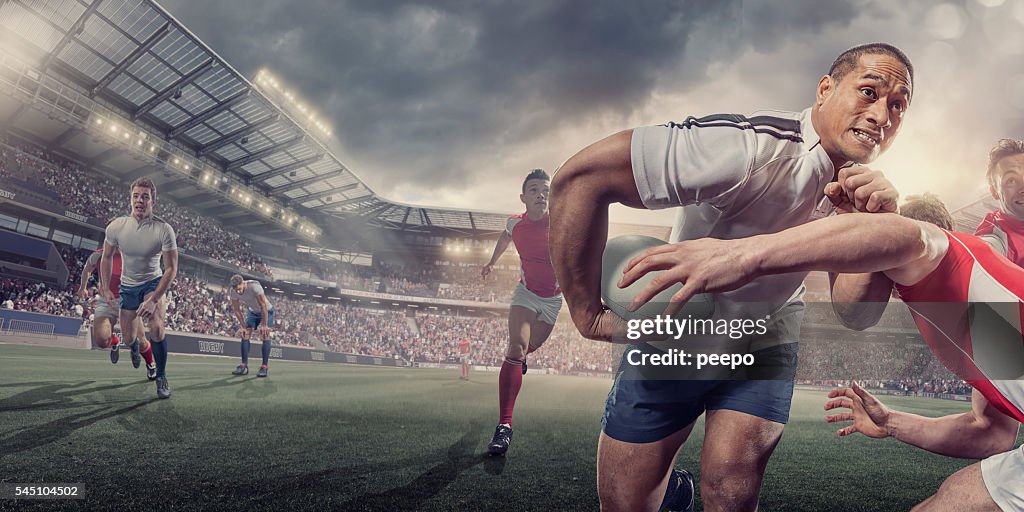 Rugby Player Running With Ball Whilst Being Tackled During Match