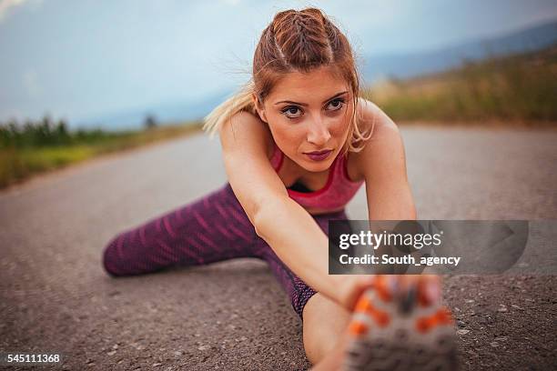 girl streching for training - pink shoe stock pictures, royalty-free photos & images