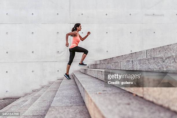 latina sports woman running up outdoor stairway in berlin - challenge stock pictures, royalty-free photos & images