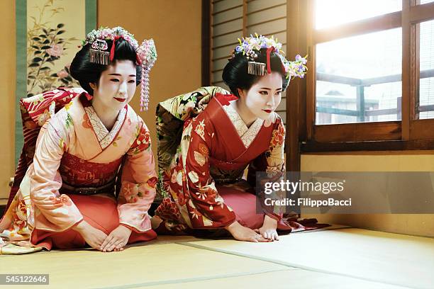 young maiko praying together - geisha in training stock pictures, royalty-free photos & images