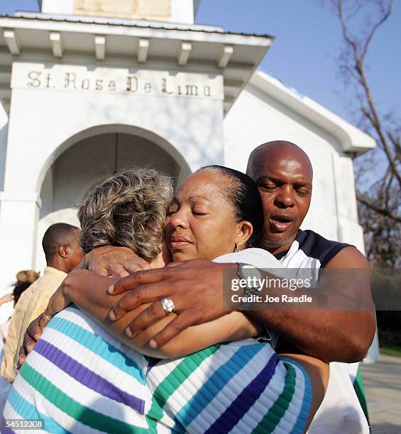 Delorise Dorsey and Sam Dorsey hug Terry McQueen as they leave the St. Rose De Lima mass September 4, 2005 in Bay St Louis, Mississippi. They all had...
