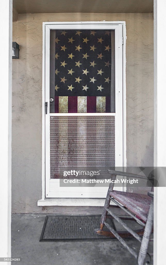 An American flag displayed on a porch
