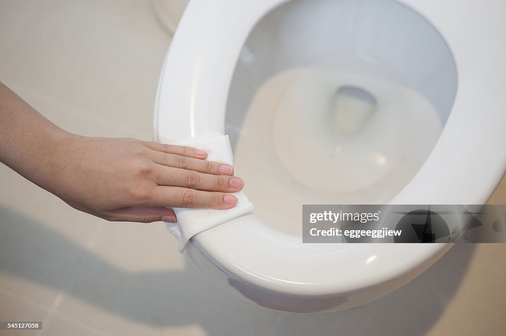 Cleaning on toilet.