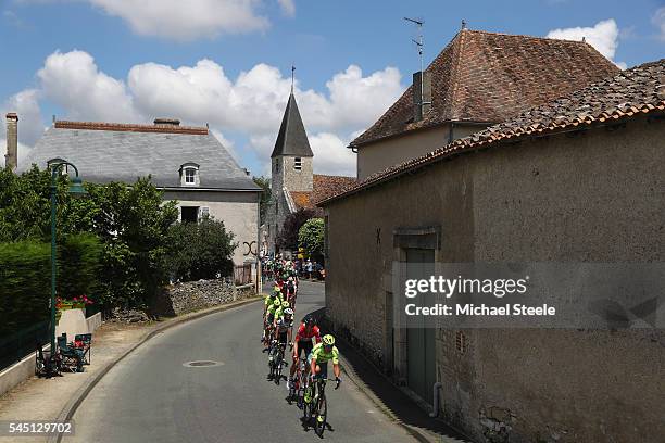Maciej Bodnar of Poland and Tinkoff followed by Lars Bak of Denmark and Lotto Soudal lead the peloton through the village of La Cantiere during stage...
