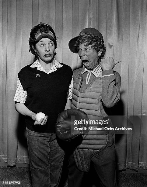 Actress Martha Raye poses with Harpo Marx for the "The Martha Raye Show" in New York, New York.