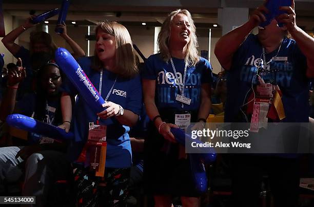 Delegates make noise with thundersticks as they wait for Democratic presidential candidate Hillary Rodham Clinton to address the 95th Representative...