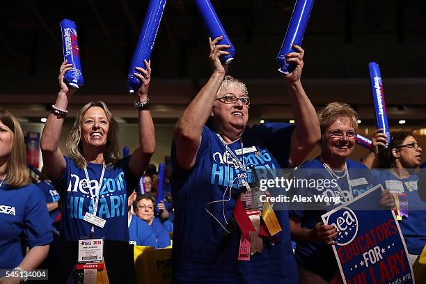 Delegates make noise with thundersticks as they wait for Democratic presidential candidate Hillary Rodham Clinton to address the 95th Representative...