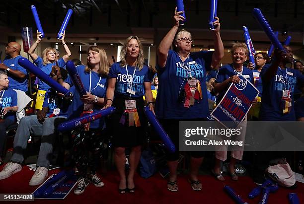 Delegates make noise with thundersticks as they wait for Democratic presidential candidate Hillary Rodham Clinton to address the 95th Representative...