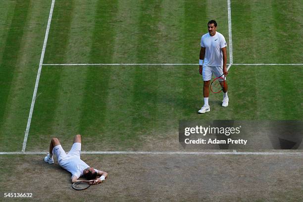 Radek Stepanek of The Czech Republic and Nedad Zimonjic of Serbia react as they play against Mike Bryan of The United States and Bob Bryan of The...