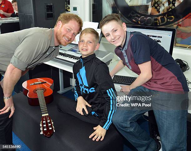 Prince Harry poses for a photo with young boys as he visits the Wigan Youth Zone, a purpose-built youth facility that provides a safe and fun...