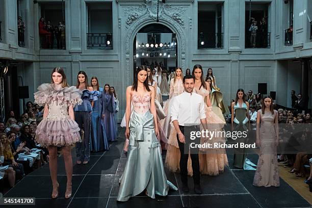 Designer Alexis Mabille poses with models during the Alexis Mabille Haute Couture Fall/Winter 2016-2017 show as part of Paris Fashion Week on July 5,...