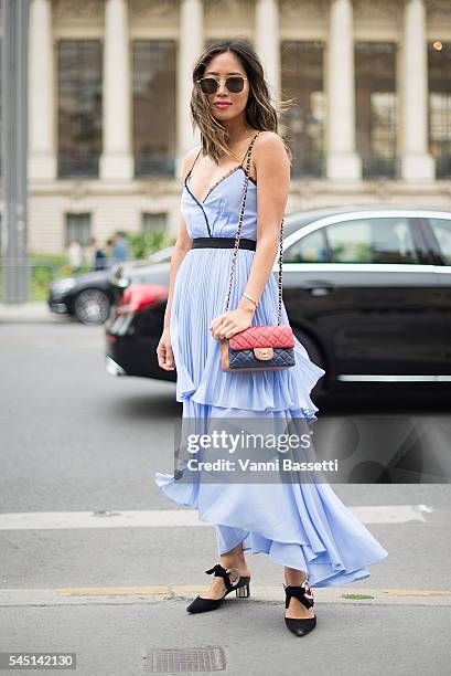 Aimee Song poses with a Chanel bag after the Chanel show at the Grand Palais during Paris Fashion Week Haute Couture FW 16/17 on July 5, 2016 in...