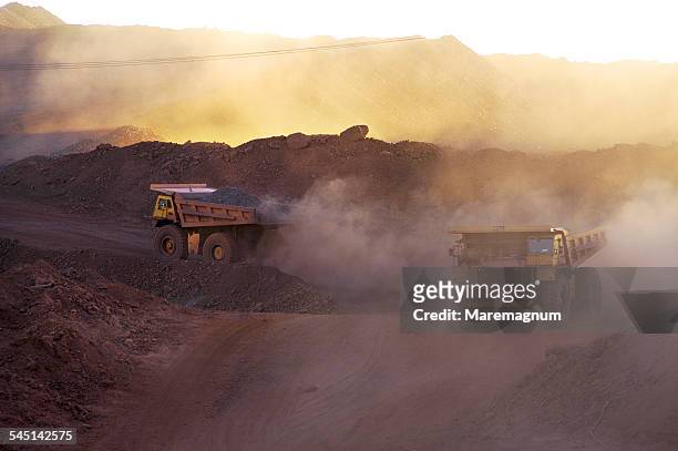 big trucks working in the mine - mining natural resources stock pictures, royalty-free photos & images