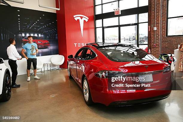 Tesla model S sits parked in a new Tesla showroom and service center in Red Hook, Brooklyn on July 5, 2016 in New York City. The electric car company...