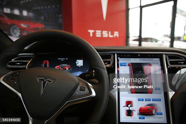 The inside of a Tesla vehicle is viewed as it sits parked in a new Tesla showroom and service center in Red Hook, Brooklyn on July 5, 2016 in New...