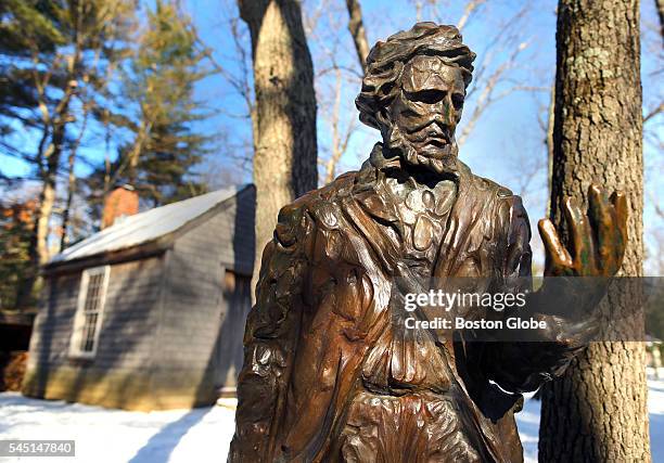 Statue of Henry David Thoreau in front of a reproduction of his cabin at the Walden Pond Reservation in Concord, Mass., on Jan. 20, 2016.