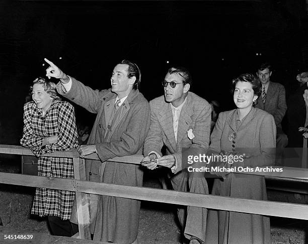 Frances Seymour with actor Henry Fonda, actor Gary Cooper with wife Veronica Balfe at Hollywood Park Racetrack in Los Angeles, California.