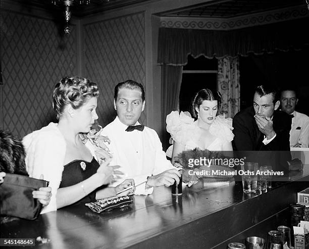 Actor Gary Cooper and wife Veronica Balfe stand a the bar during an event in Los Angeles, California.