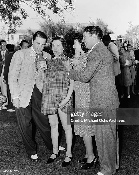 Comedian Fanny Brice clowns around with friends during her birthday party in Los Angeles, California.