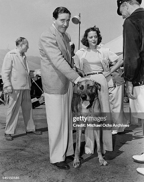 Actor John Boles and actress Carol Hughes attend an event with a dog in Los Angeles, California.